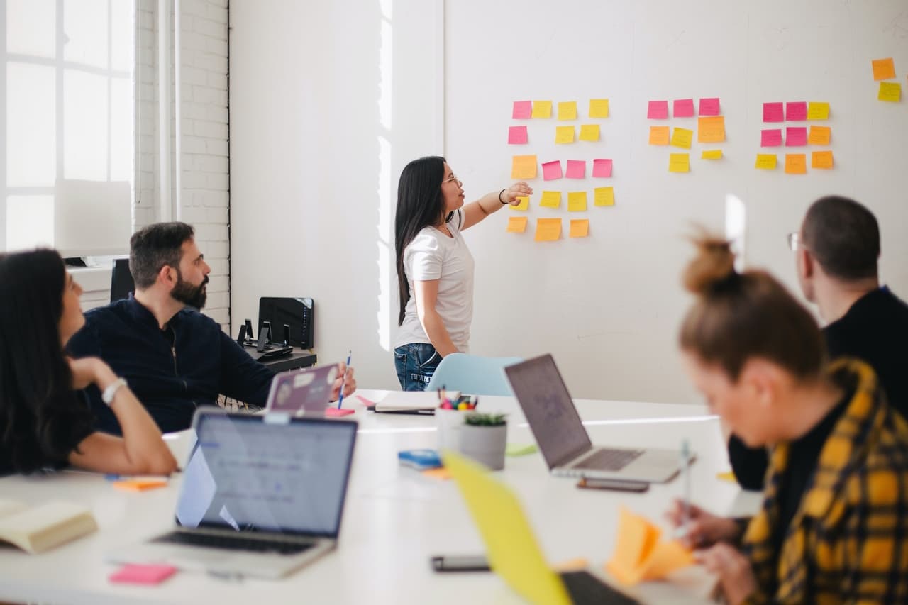 a team meeting where people gather and discuss