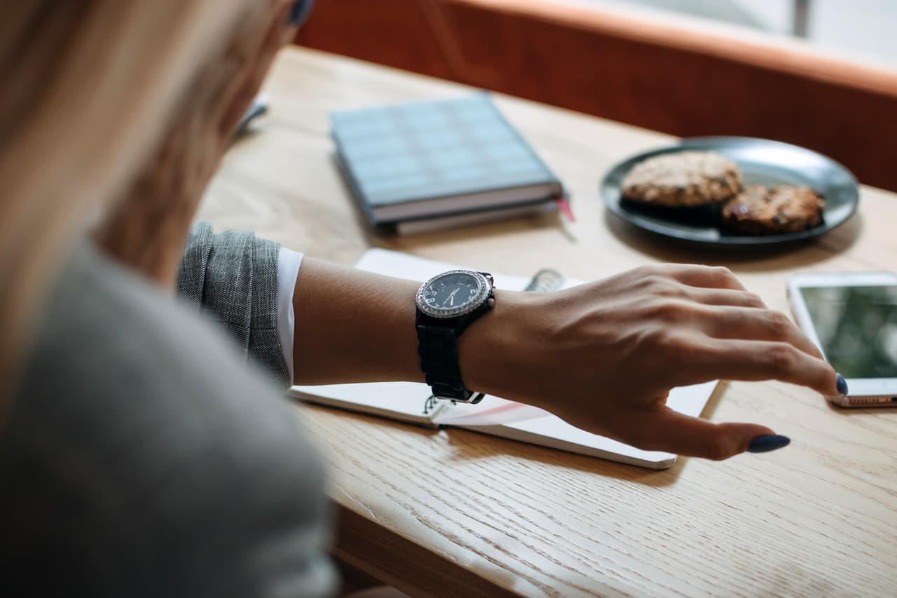 a woman checking the time on her watch for time management