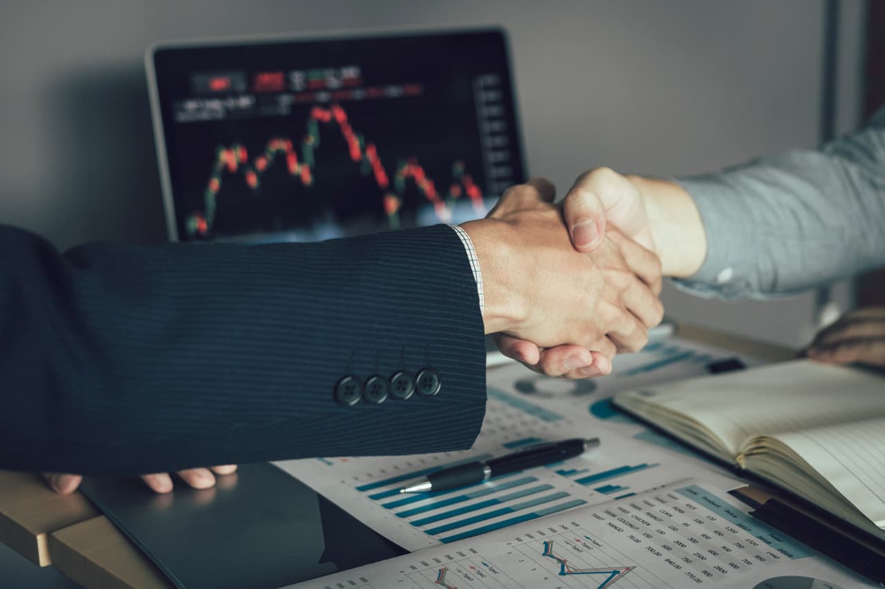 two businessmen handshaking from a view only