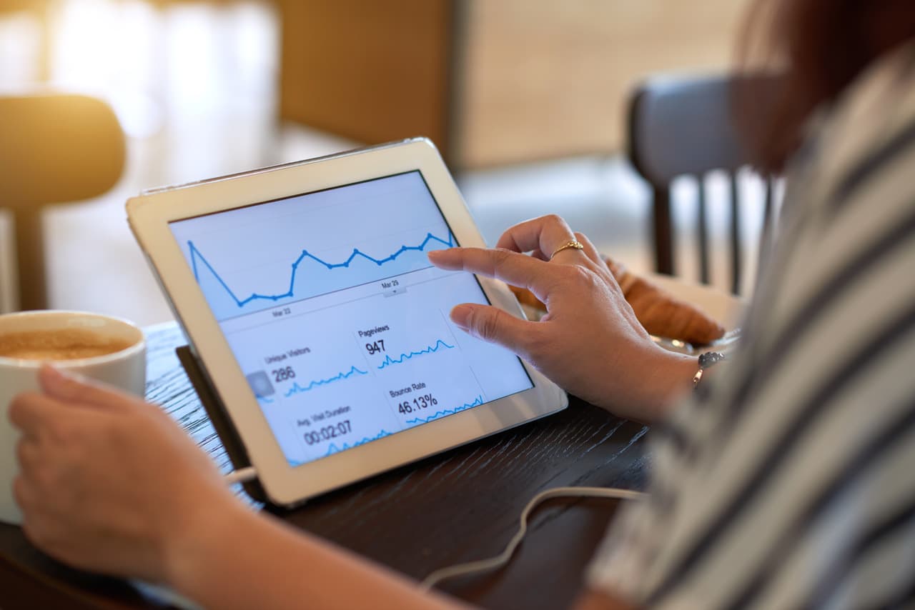 a person analyzing numbers and looking at a tablet