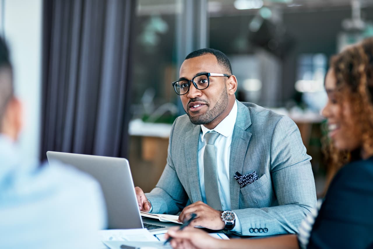 a man in a meeting listening to people intently