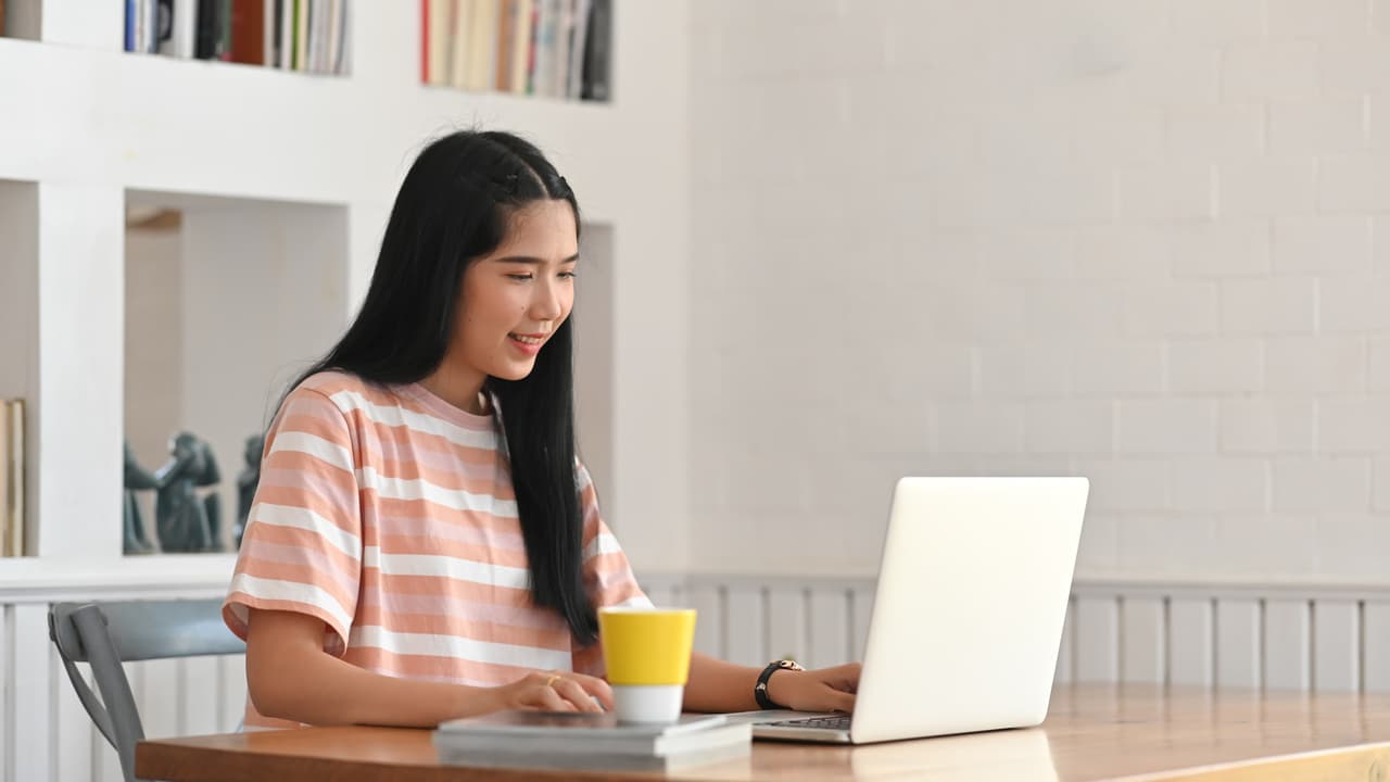 a woman dealing with her computer on her table
