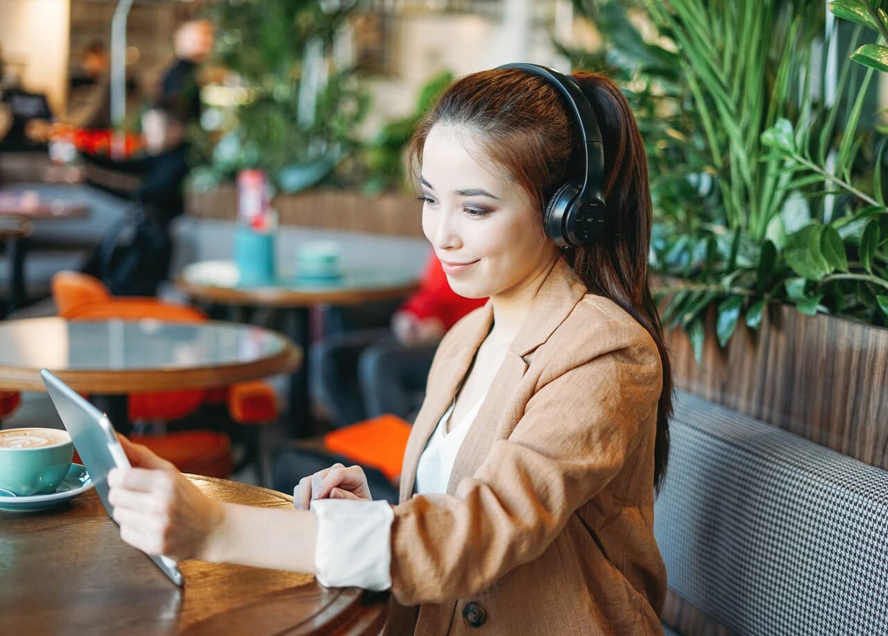 young student in headphones learning a language with an AI chatbot, illustrating Duolingo multilingual chatbot example