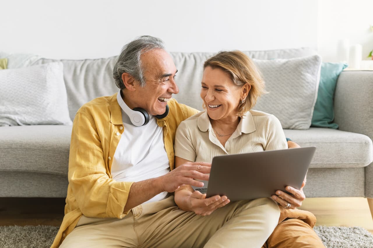 a senior couple resting at their home and doing online shopping