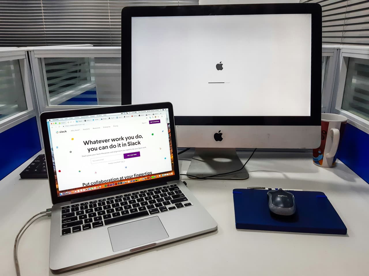 Mac screen loading and a Slack app setting up on laptop