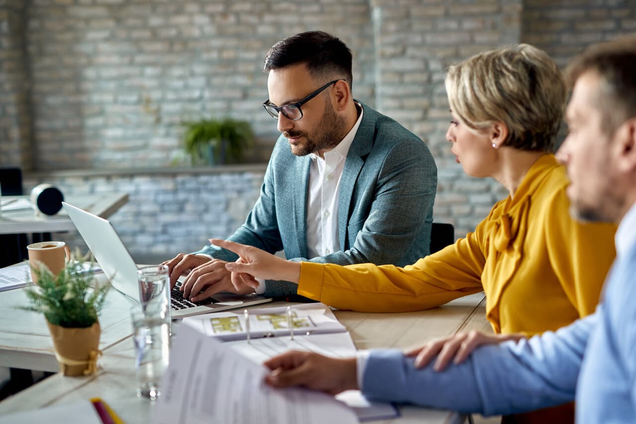 a man using laptop while having a meeting