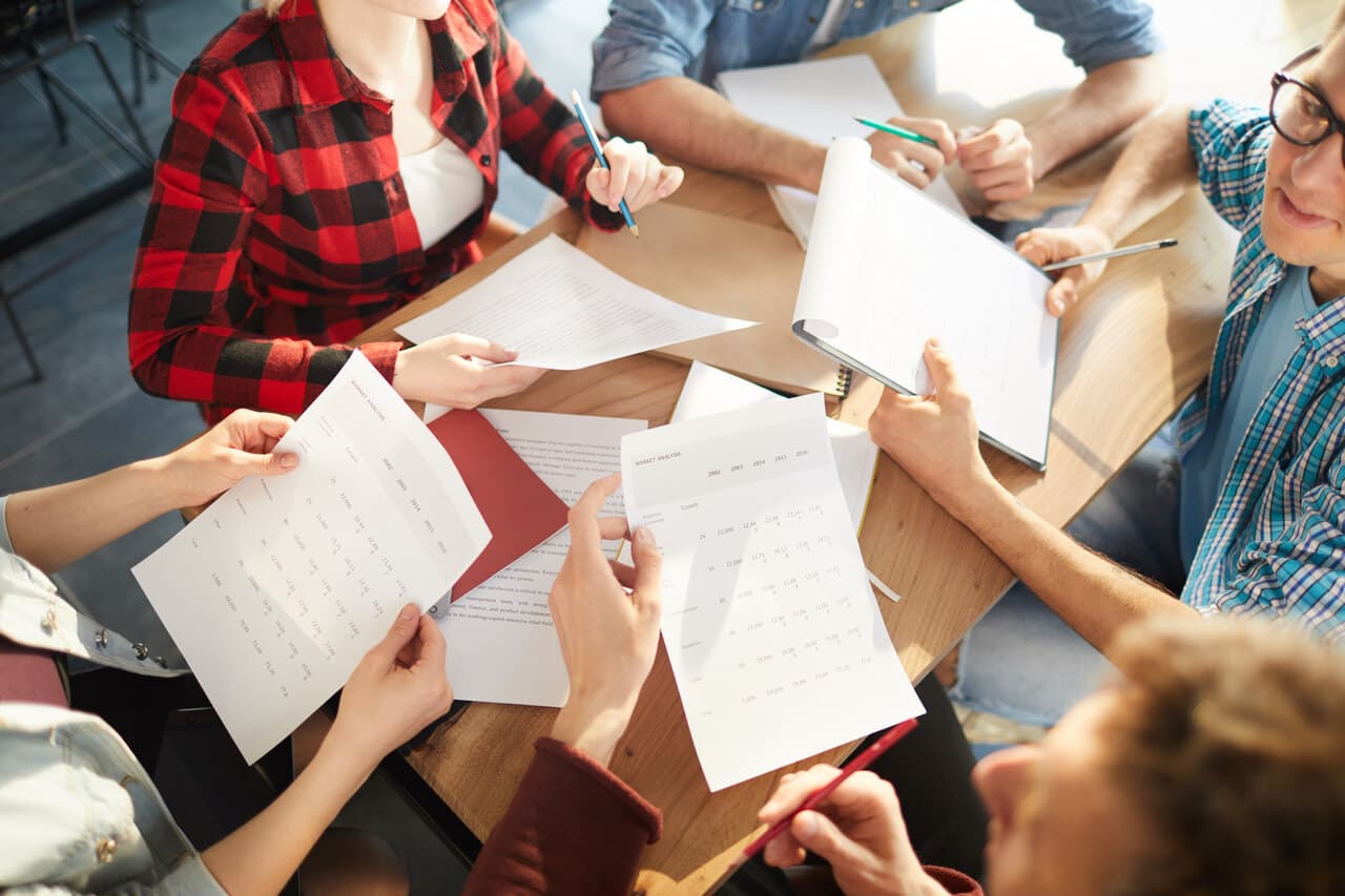 people in a meeting dealing with reports